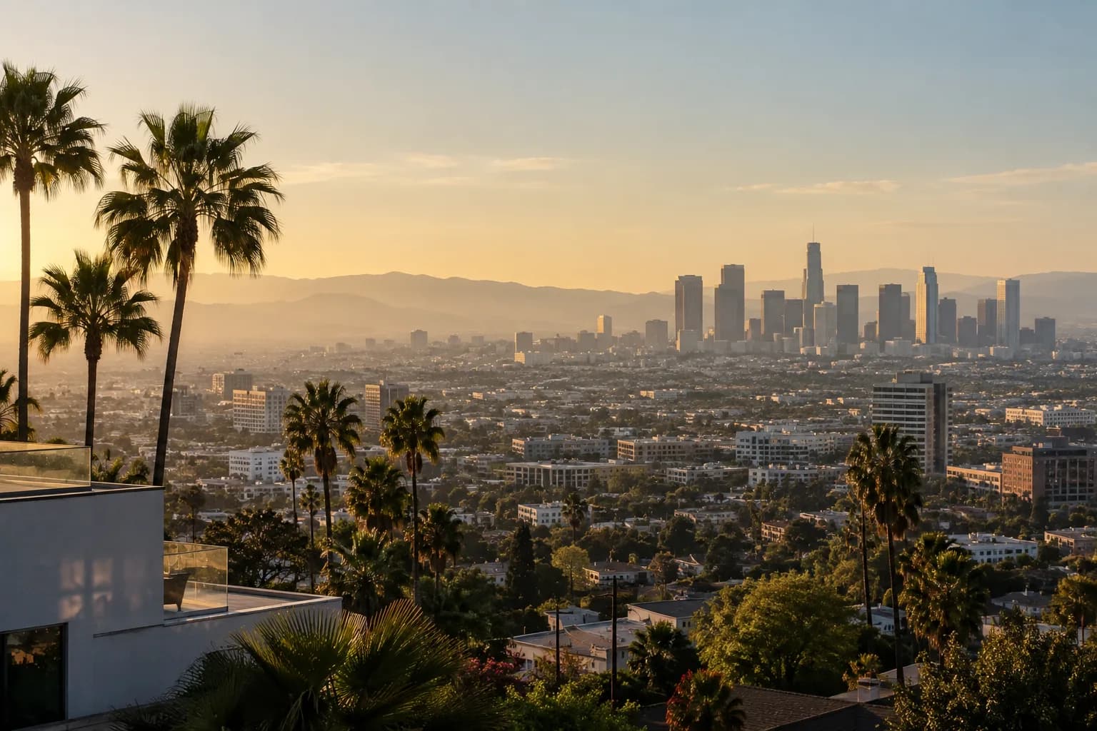 Downtown Los Angeles skyline framed by palm trees