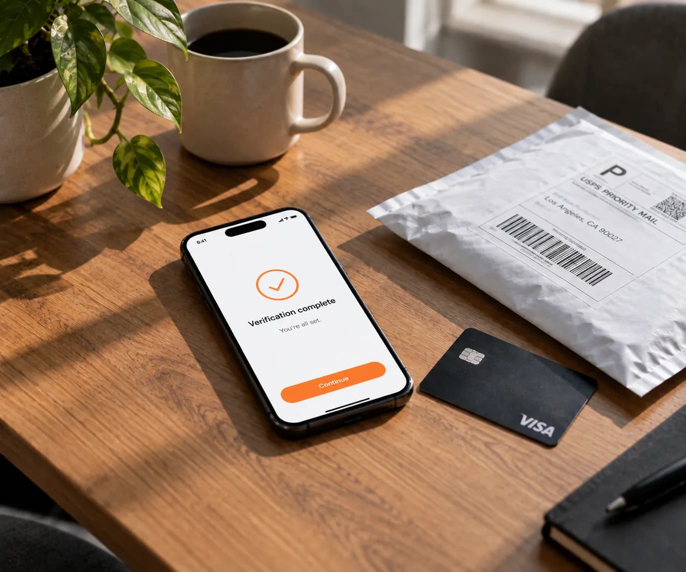 A phone, a payment card and a shipping label laid out on a desk