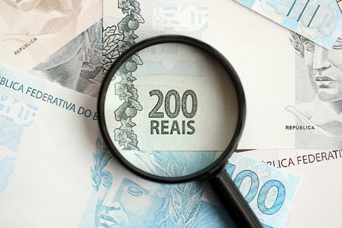 brazilian-reais-banknotes-and-magnifying-glass