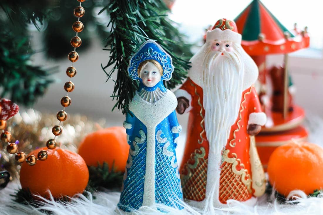 Christmas Decorations (Russian Santa Claus and Snow Maiden) Standing Near With Christmas Tree